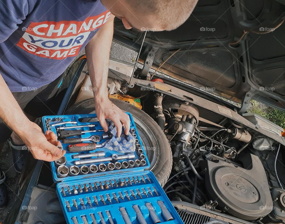 The mechanic prepares tools for self-repair of the car