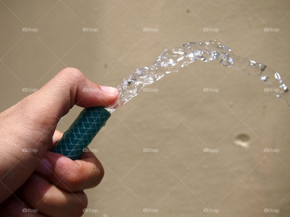 Hand holding a water hose