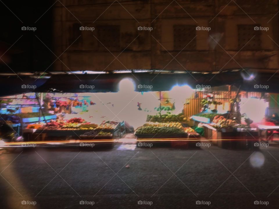Night view of a traditional store by street. Long exposure, blured and defocused