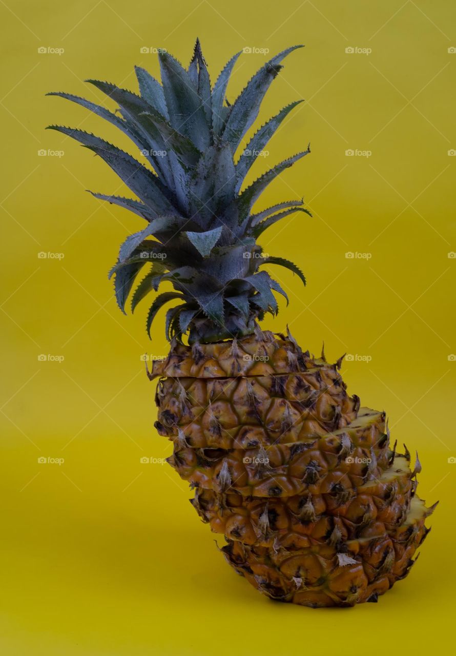 Pineapple with yellow background
