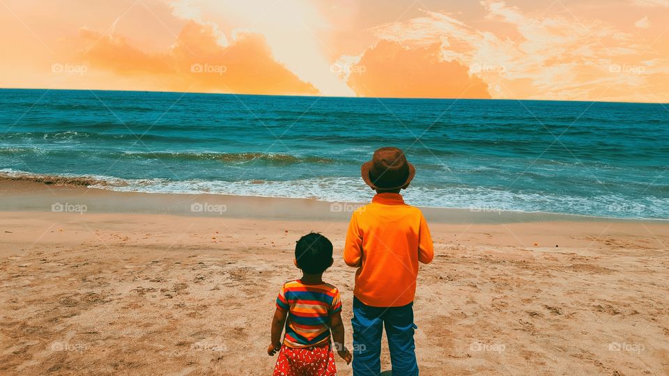 Enjoying sunset with little brother in Beach