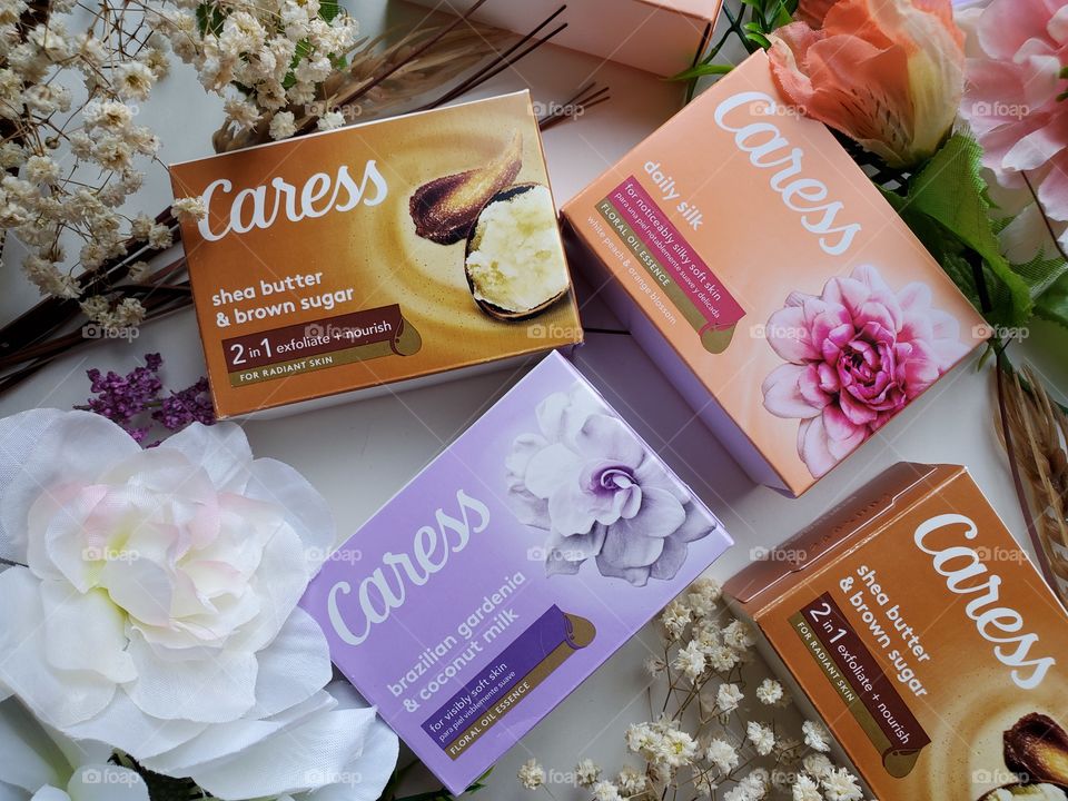 The new Caress bars single packs variety of three kinds,  surrounded by matching flowers on a white background.