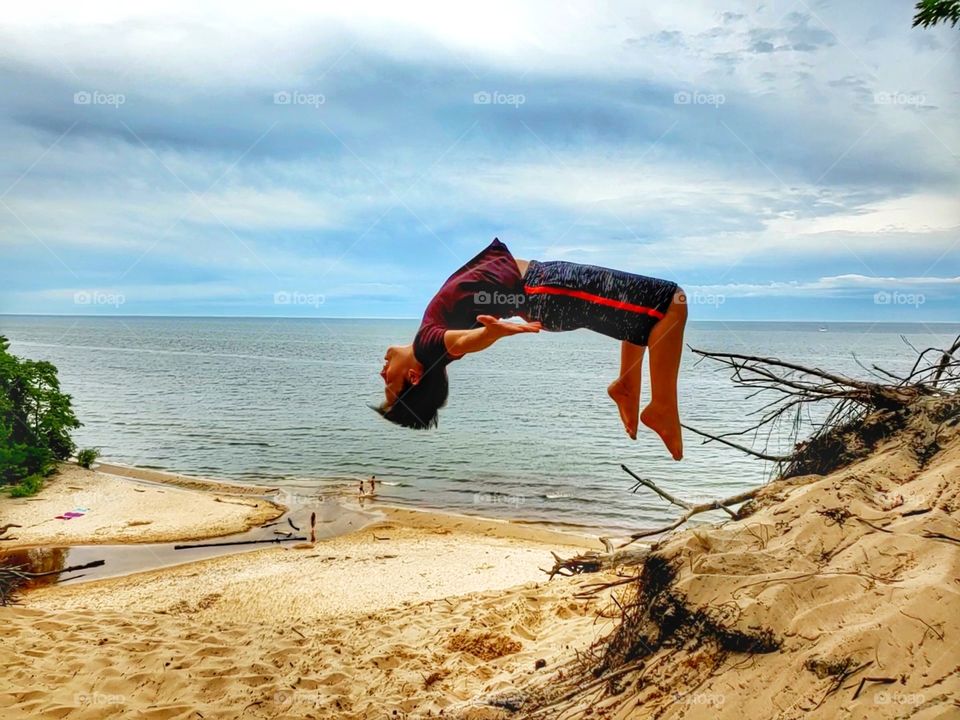 Backflip on sand dune