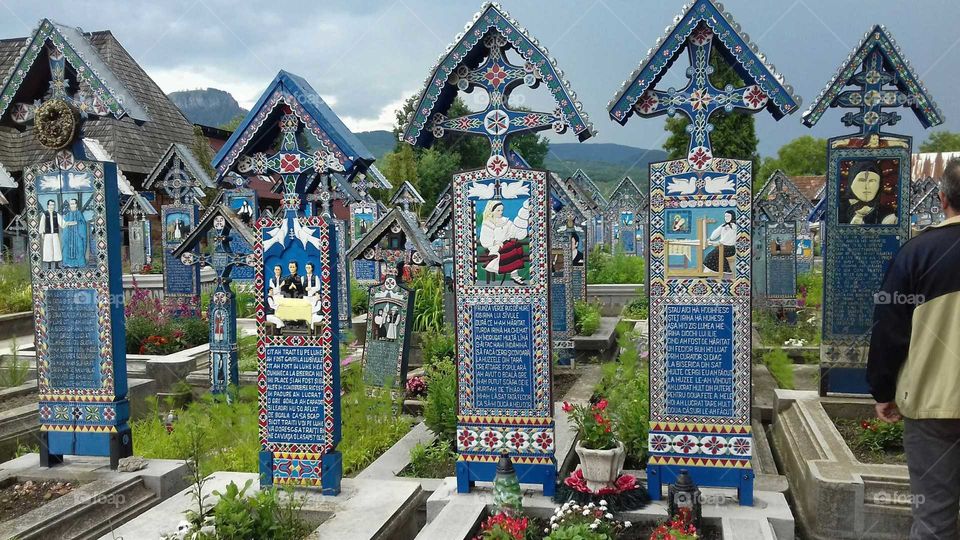 Man Gazing at Colorfull Grave Crosses, Summer Culture Trip, The Merry Cemetery, Sâpânța, Mara Mureş, Romania

Instagram Username; anita.walter.796