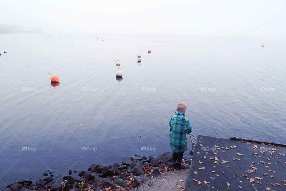 Boy playing at the lake