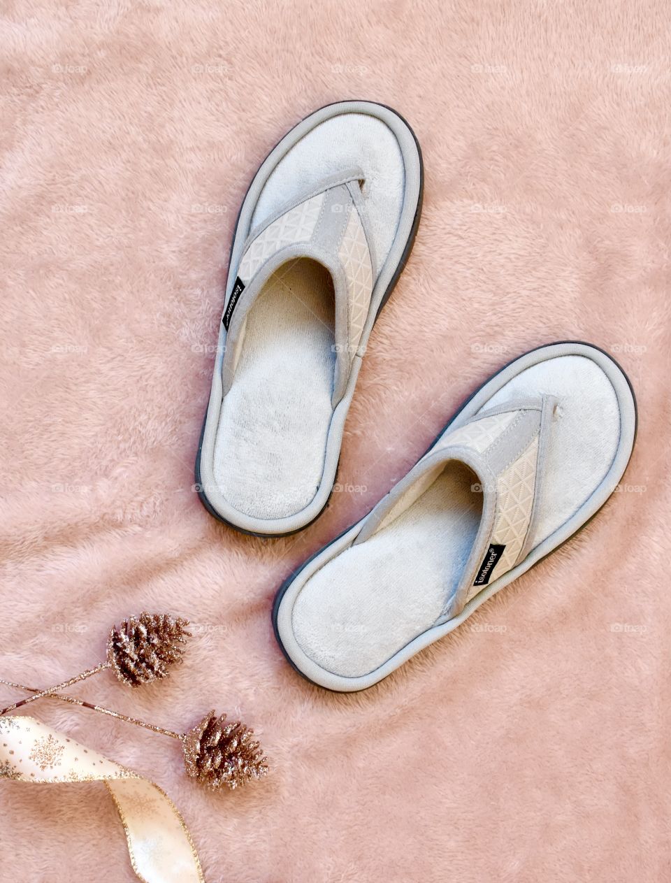 Grey Isotoner slippers in a still life flat lay Christmas set up