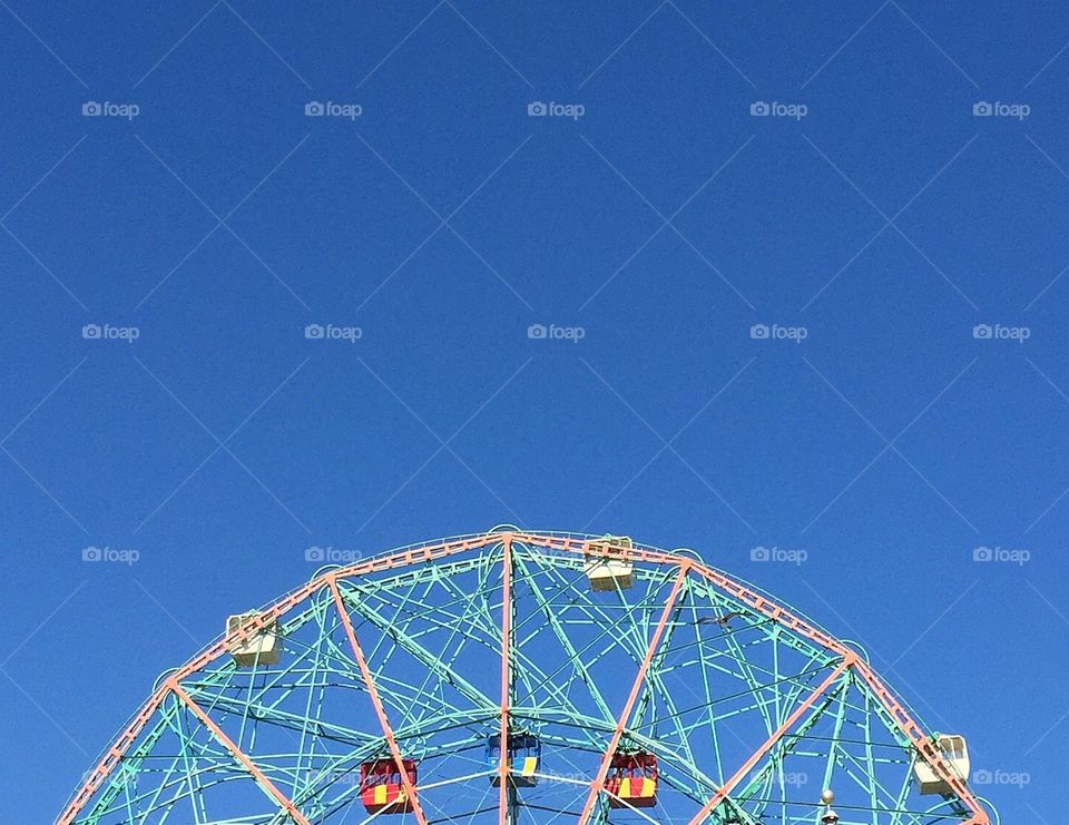 Top of ferris wheel in a blue sky