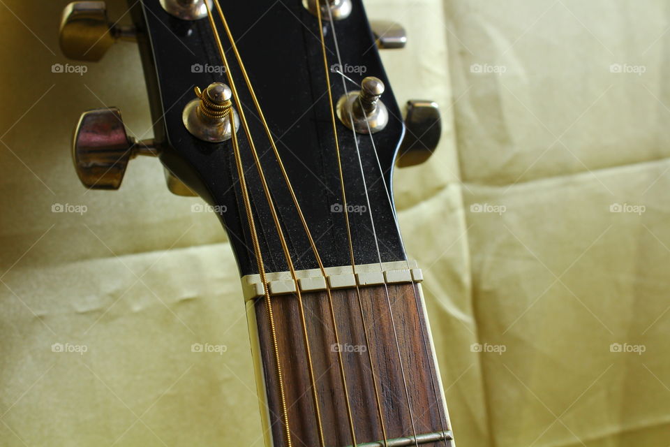 acoustic guitar on Golden textile