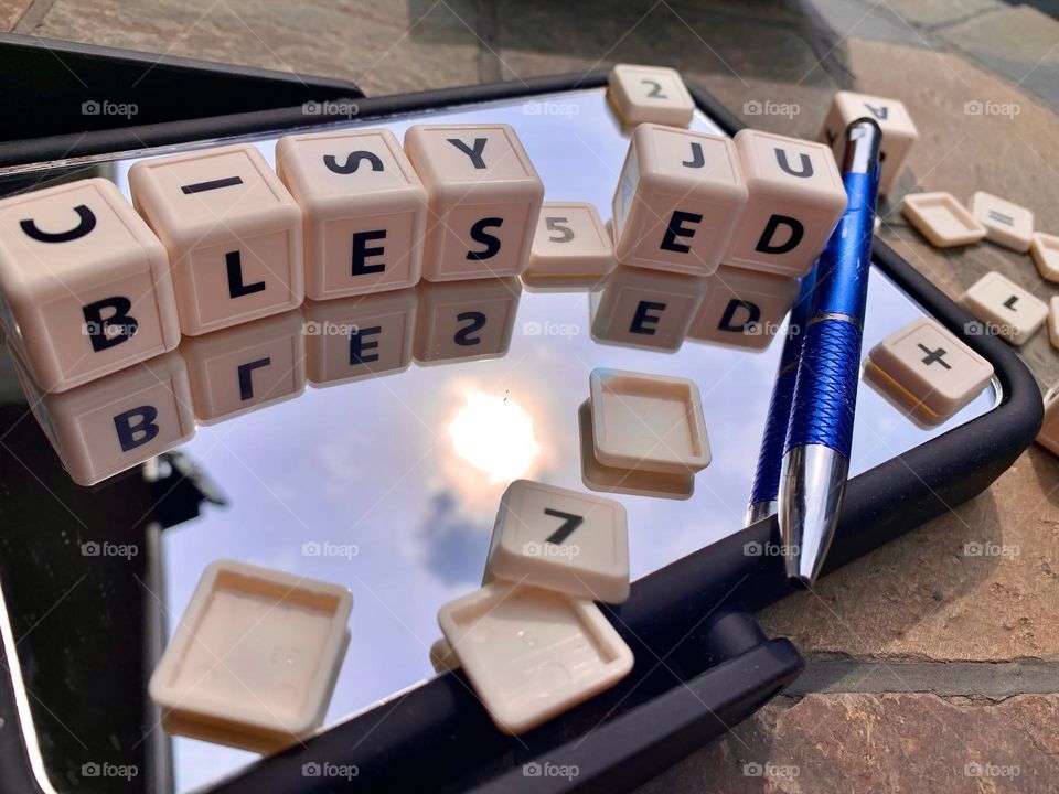 BLESSED Lettering With Educational Cubes Reflecting On A Mirror Outside, Greetings Under The Morning Sun.