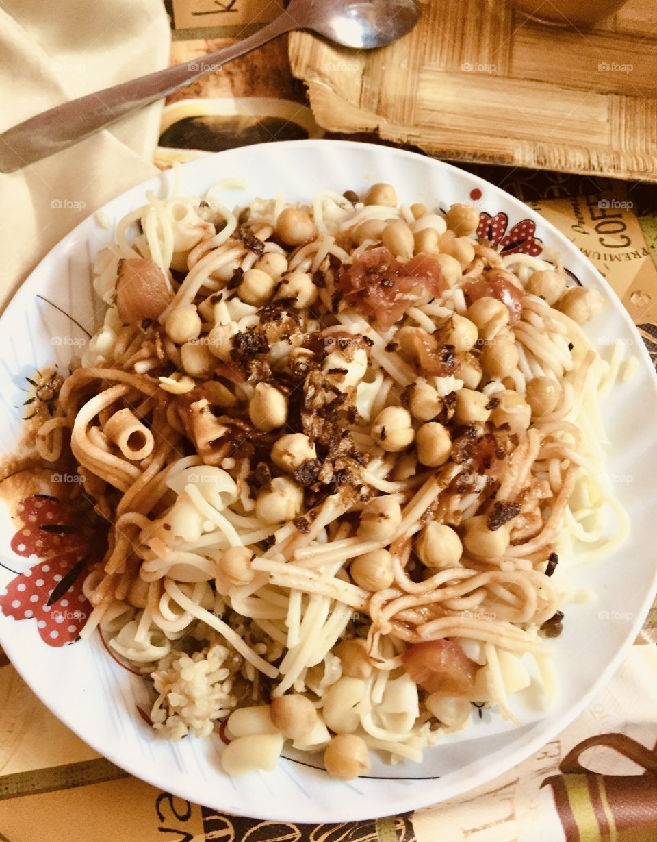 Egyptian kosheri (kushari) - high protein vegetarian dish and many ingredients, cheap but nutritious meal for poor people 