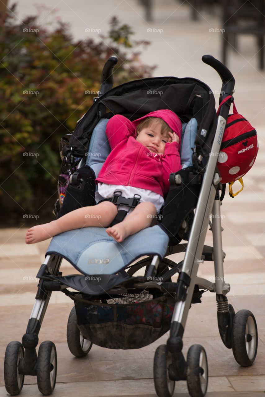 sleepy girl in a stroller