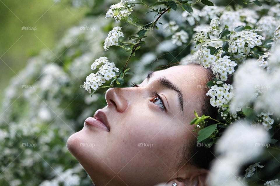 Beautiful girl in a sea of white flowers