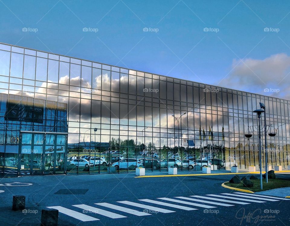 Reflections of a day gone by.  At a local sports hall/entertainment complex caught this reflection.  Thought it interesting against the blue sky that had no to little clouds.