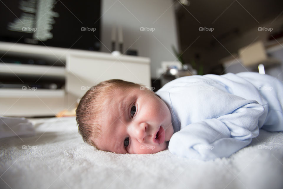 Close-up of baby lying down on bed