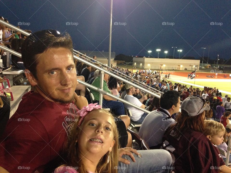 Fans of Friday night lights. Football fans watching high school Friday night football