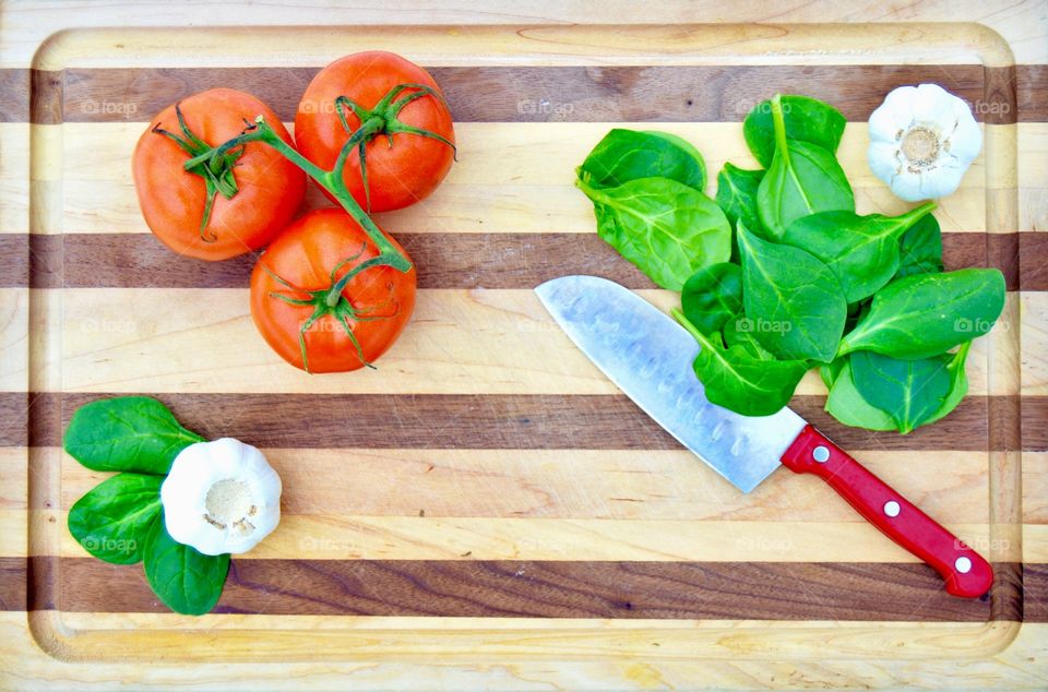 Tomato and garlic on cutting board