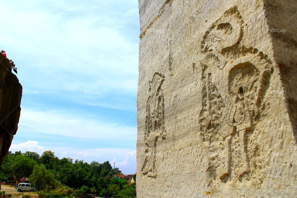 carvings of puppets in limestone