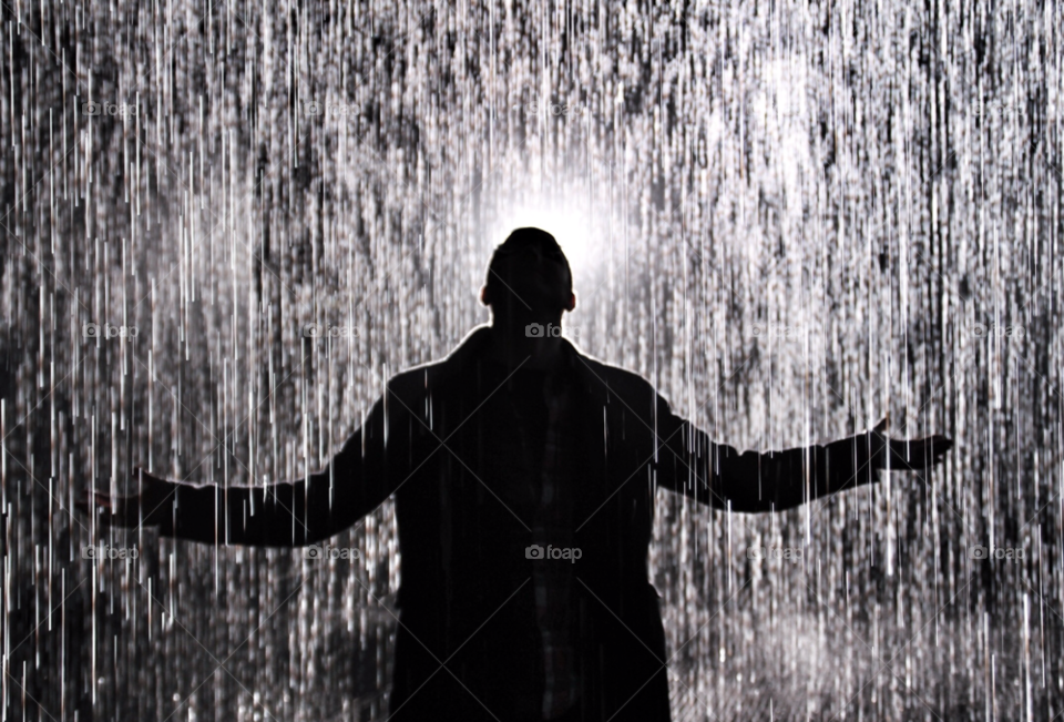 Rain. Silhouette of man in rain