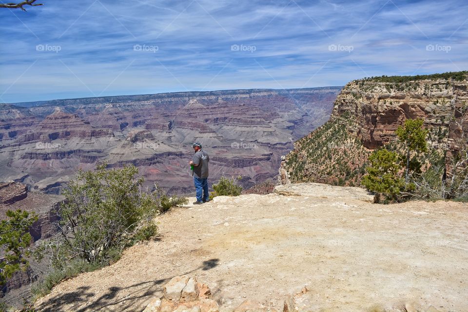 My husband standing on the side of the Grand Canyon in Arazonia 