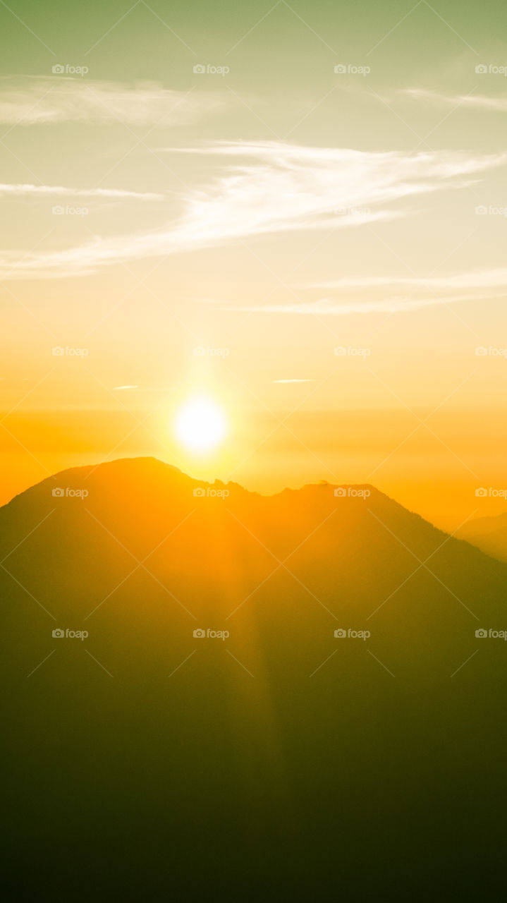 An inspiring mountain landscape. Tatry mountains in Slovakia. A beautiful wallpaper for smartphone screen. Warm summer haze, abstract gradient with perspective.