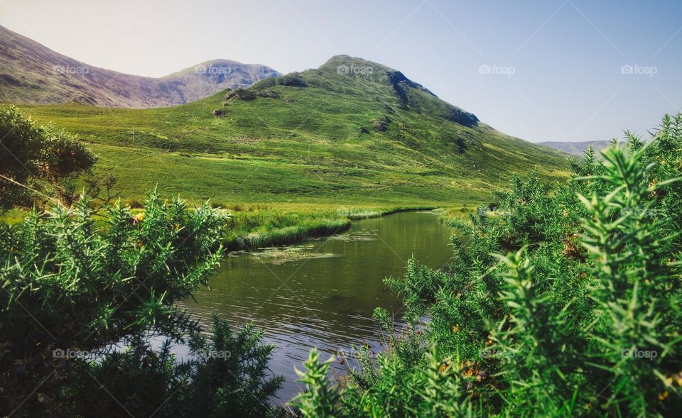 Green hills by Loch Na Fooey, lake at Connemara National park in county Galway, Ireland