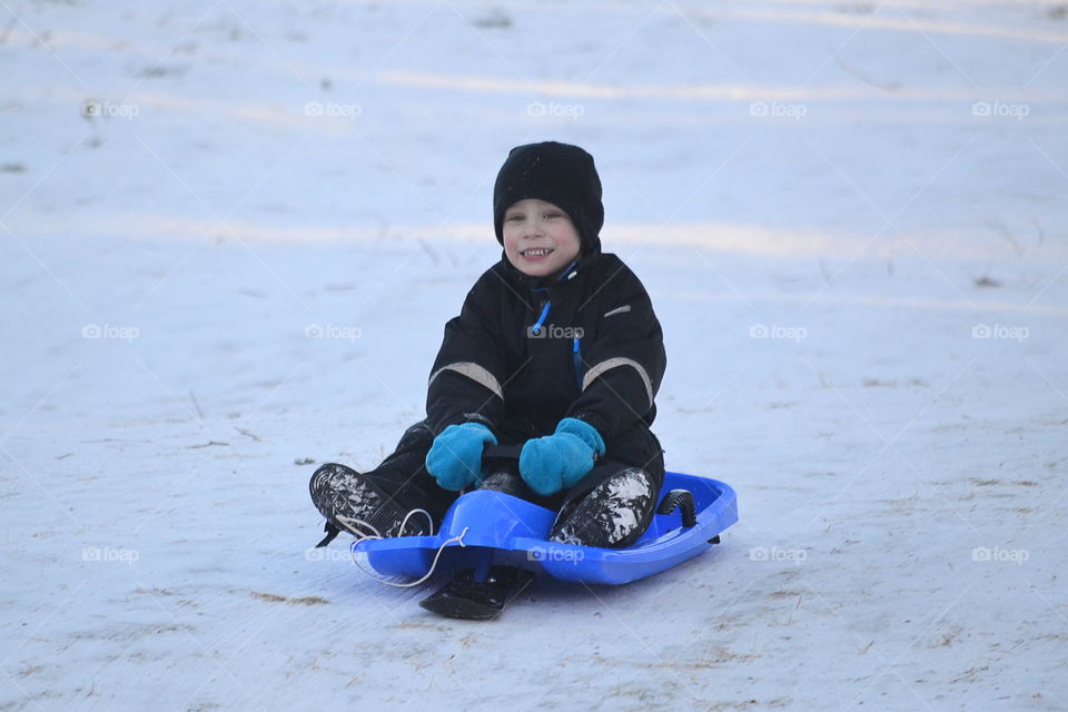 Boy going down the hill with a happy face