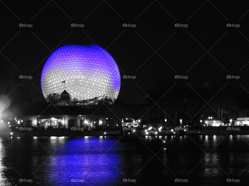 The reflection of Spaceship Earth stretches it over the waters of the World Showcase lagoon at EPCOT at the Walt Disney World Resort in Orlando, Florida.