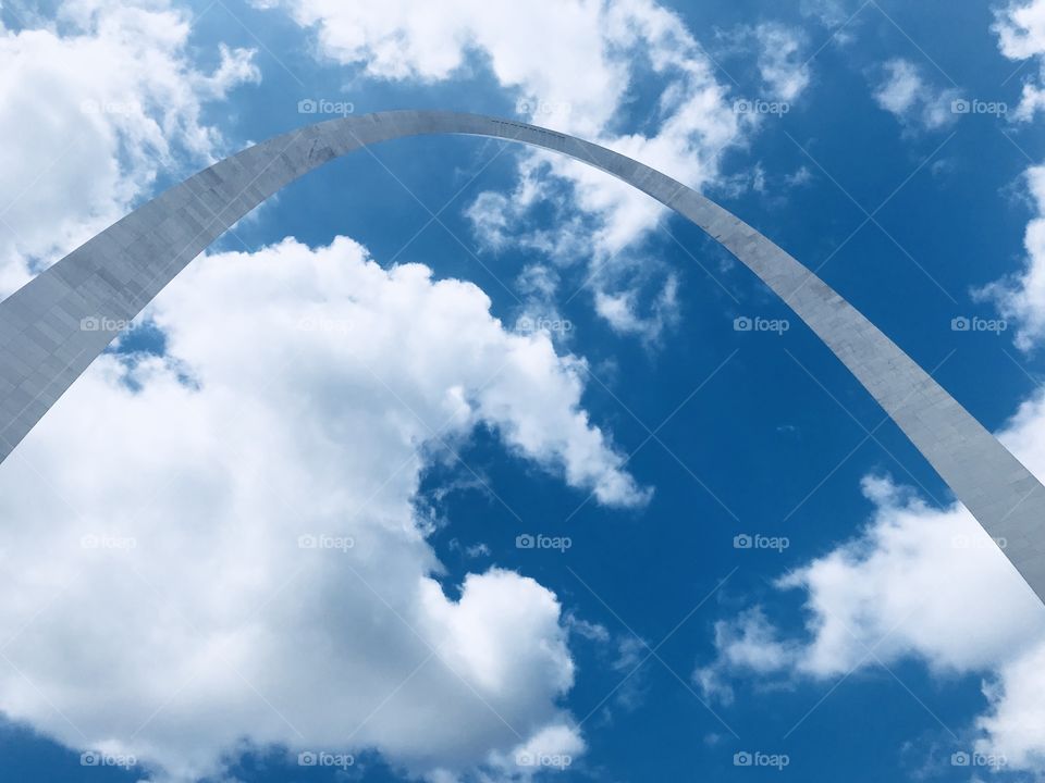 Such an amazingly beautiful day in St. Louis looking up at the Arch on a July partly cloudy blue sky