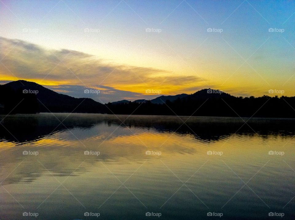 Scenic view of calm lake at sunrise