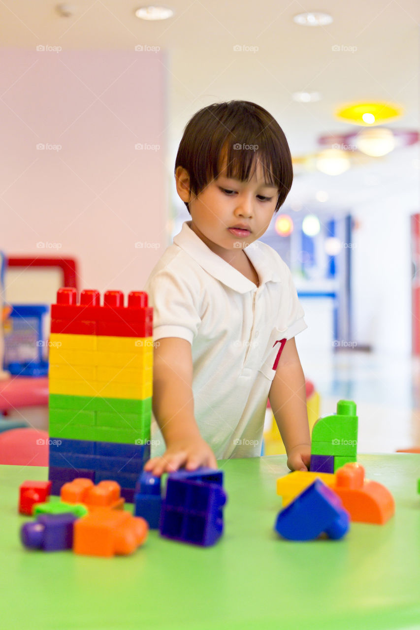 Boy playing with wooden toy