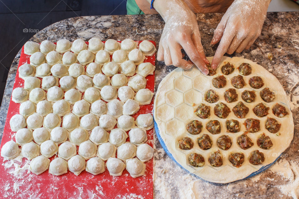 Woman is preparing meat dumplings