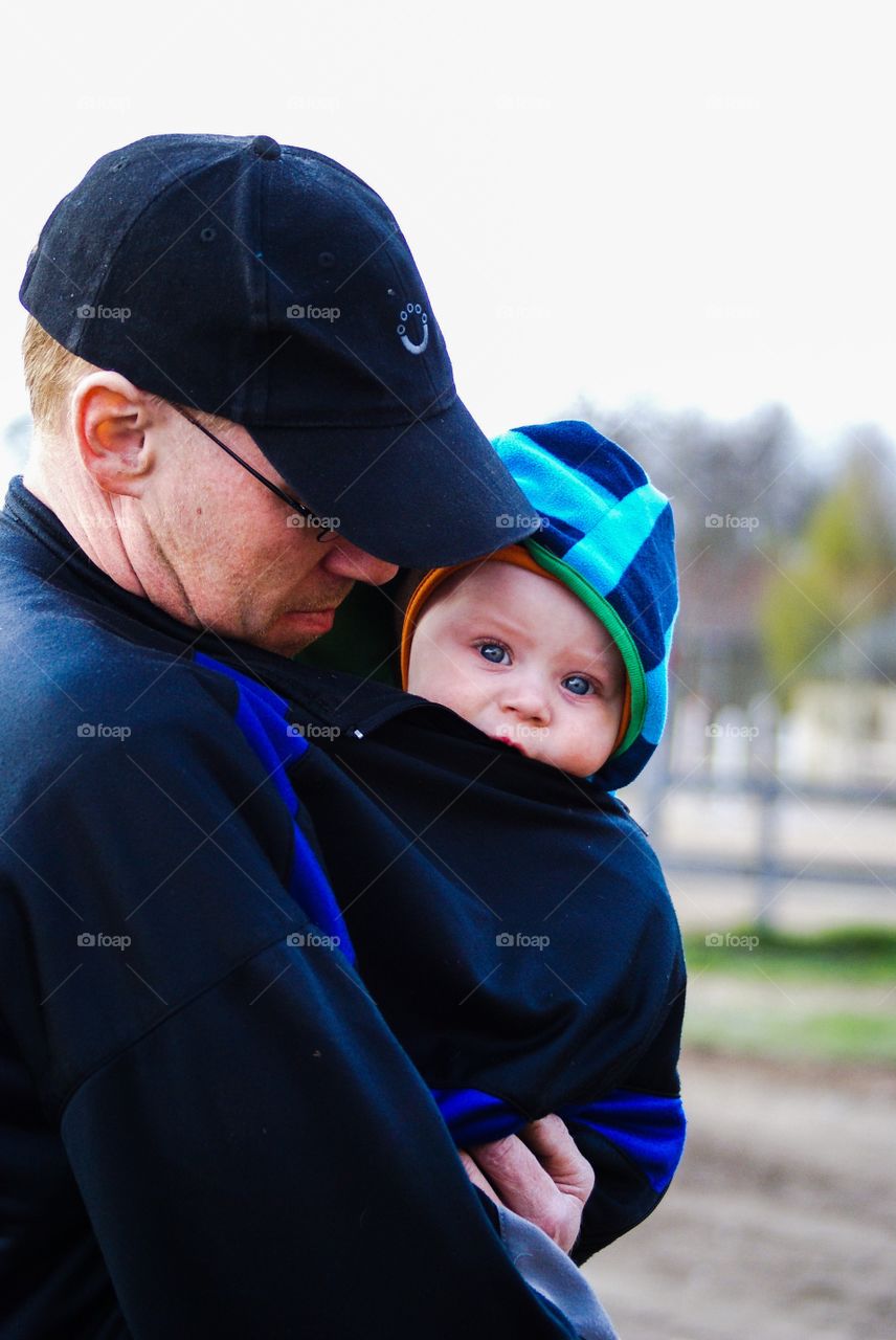 Father and son. Cute boy in his fathers arms