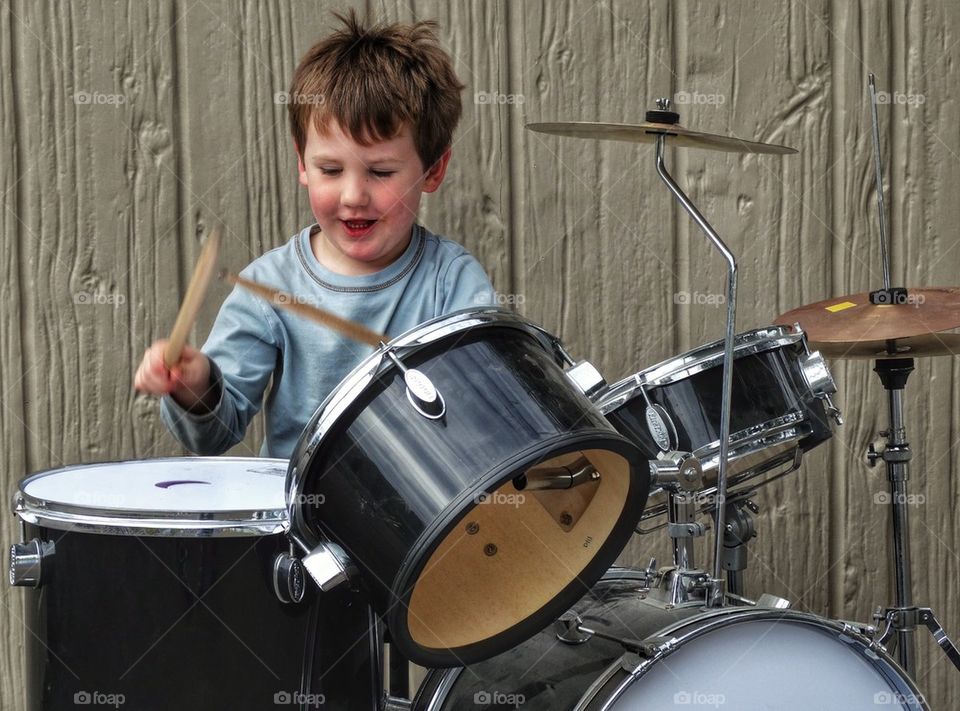 Young Boy Rocking Out On Drum Kit
