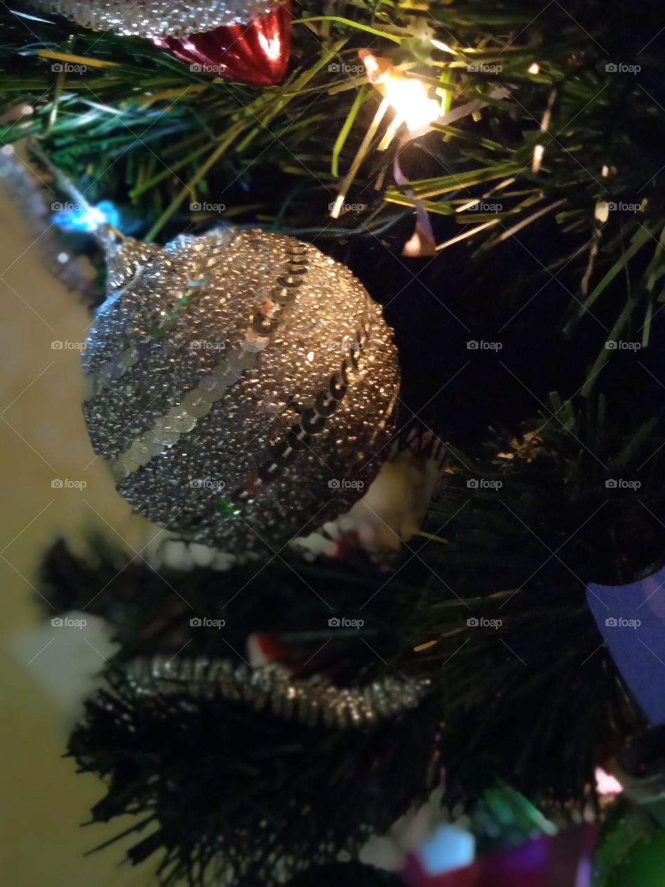 silvery Christmas ball decorated with sequins.