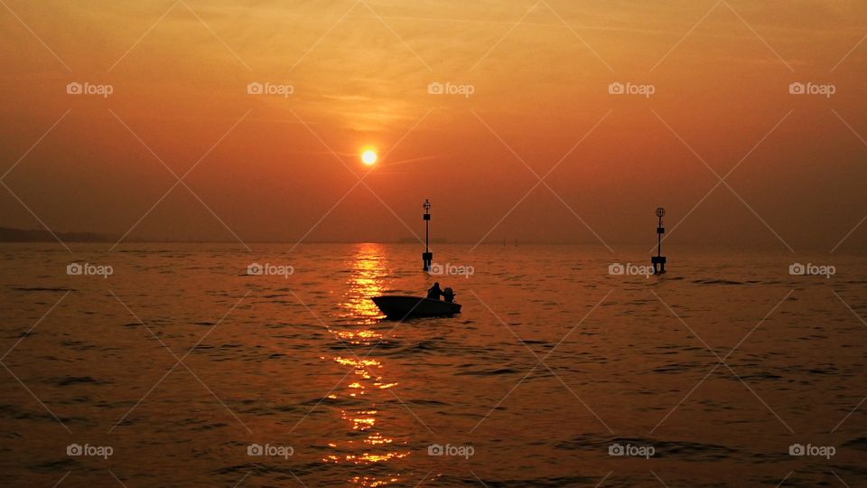 A boatman and a sunset in Venice