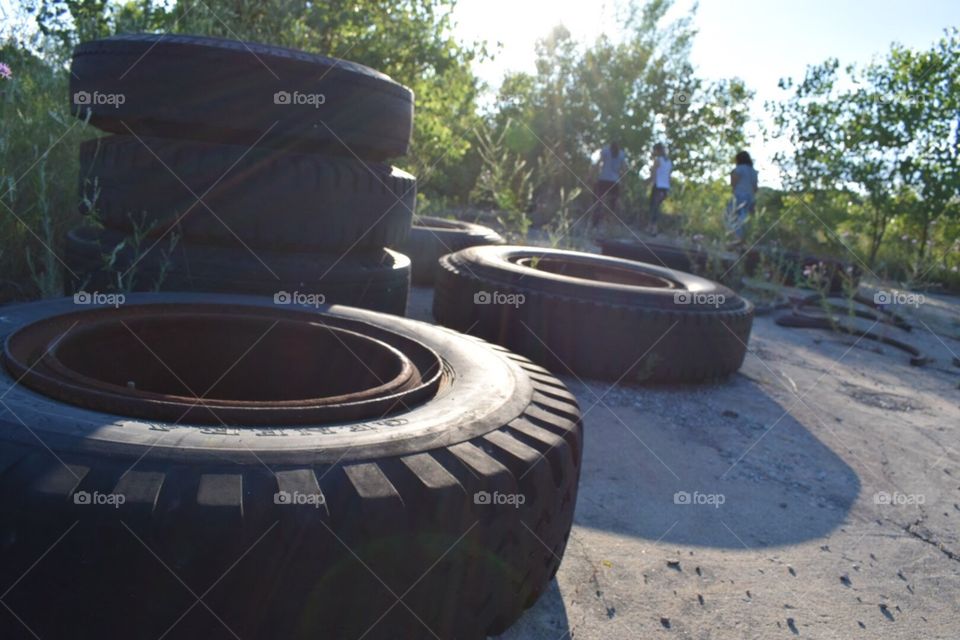 Tires piled in the sun.