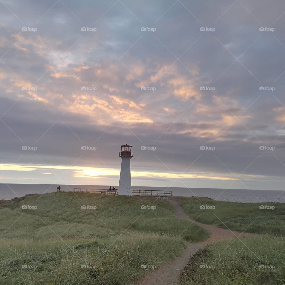 Grasslands in front of the "phare du Borgot" on sunset. Îles-de-la-Madeleine, Québec, Canada.