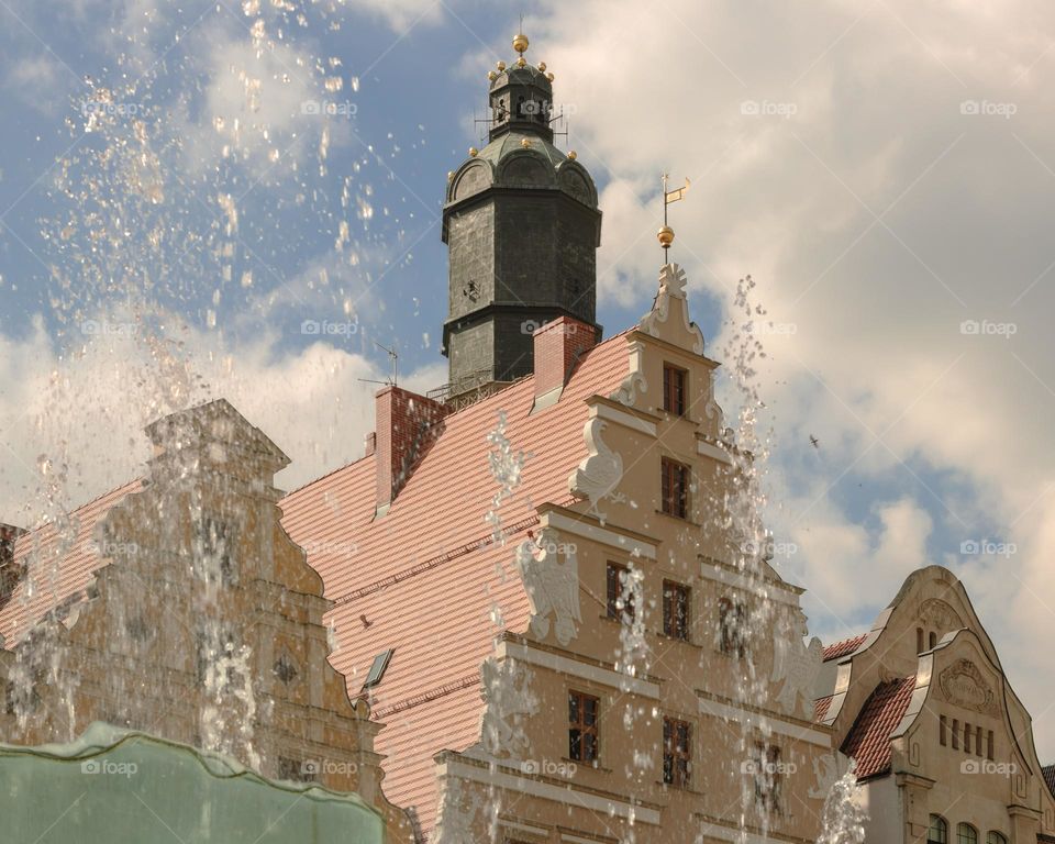 tenement houses and a fountain against the blue sky