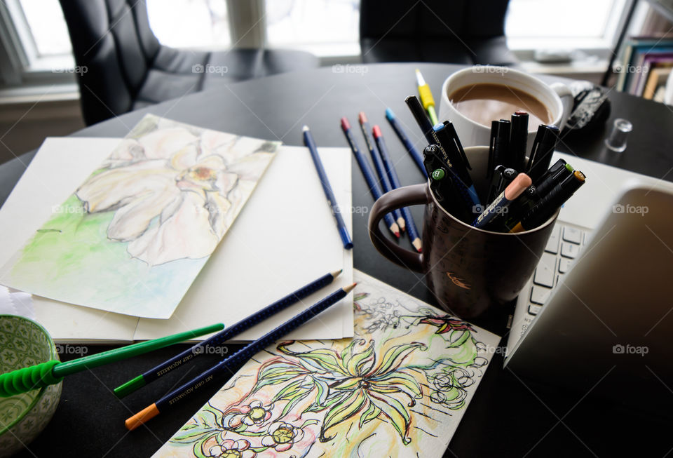 Desk with Flower sketches near window and art tools Sketching with Faber-Castell PITT Artist pens and aquarelle pencils using watercolor techniques lifestyle photography 