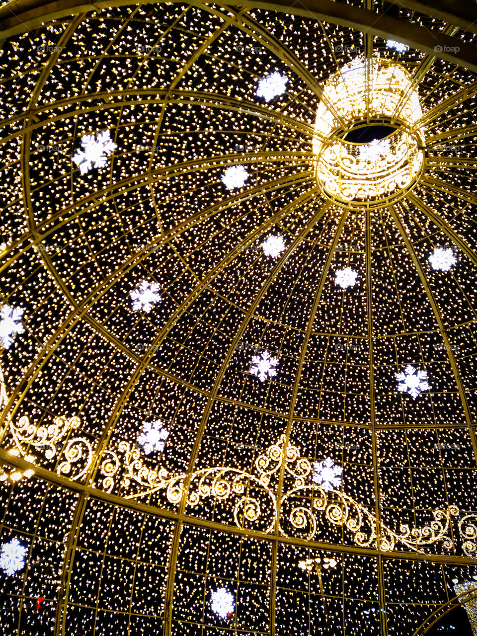 Moscow in the evening.  New Year street decorations.  A huge Christmas ball made of glowing garlands inside in front of the Bolshoi Theater