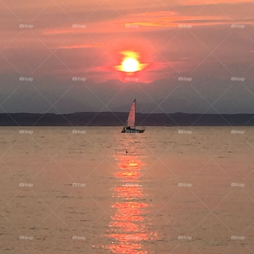 Fiery sunset. Fiery sunset and sailboat due to wildfires