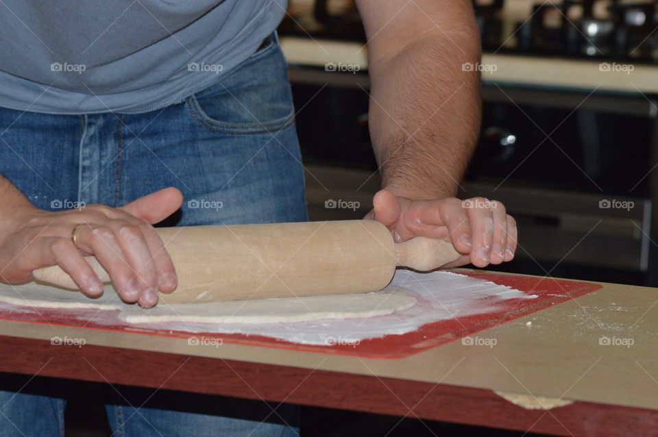 Close-up of a man rolling dough