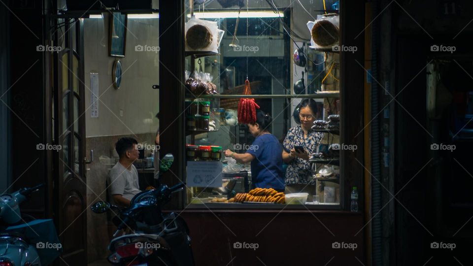 Vietnamese people working late in the evening preparing food for customers 