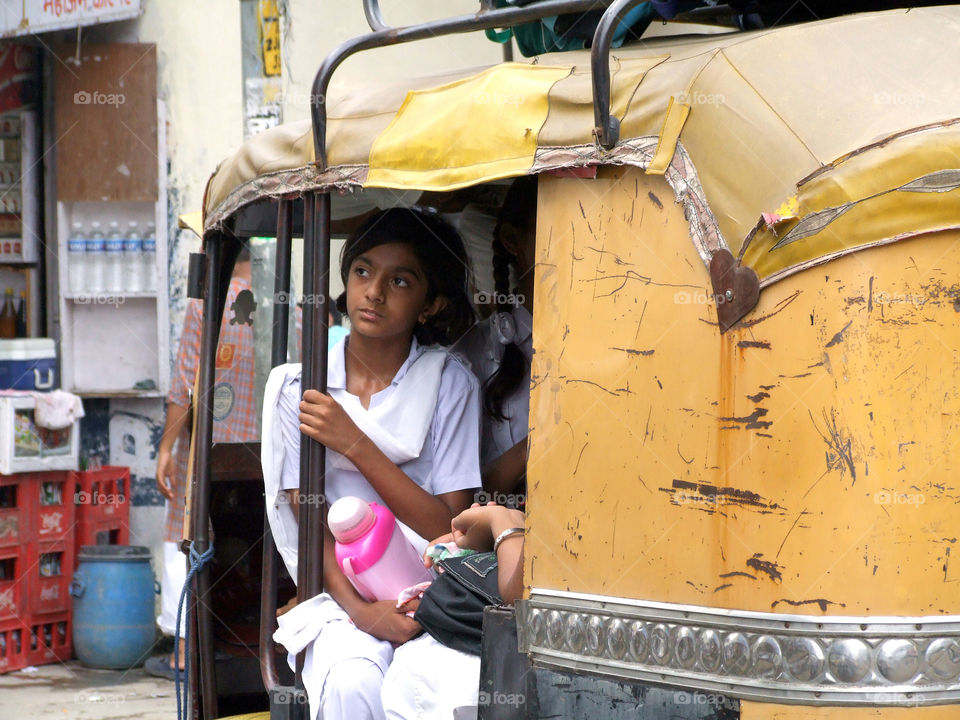Schoolgirl in rikshaw
