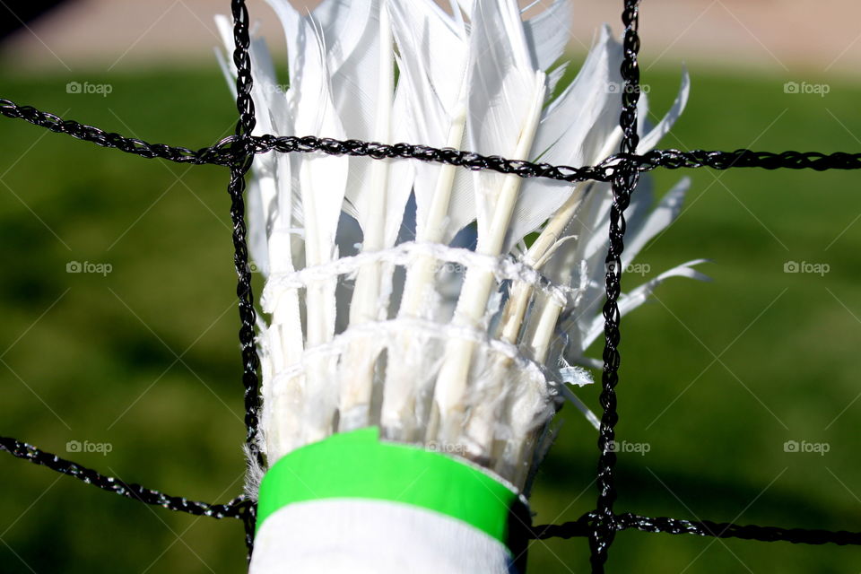 Shuttlecock stuck in net