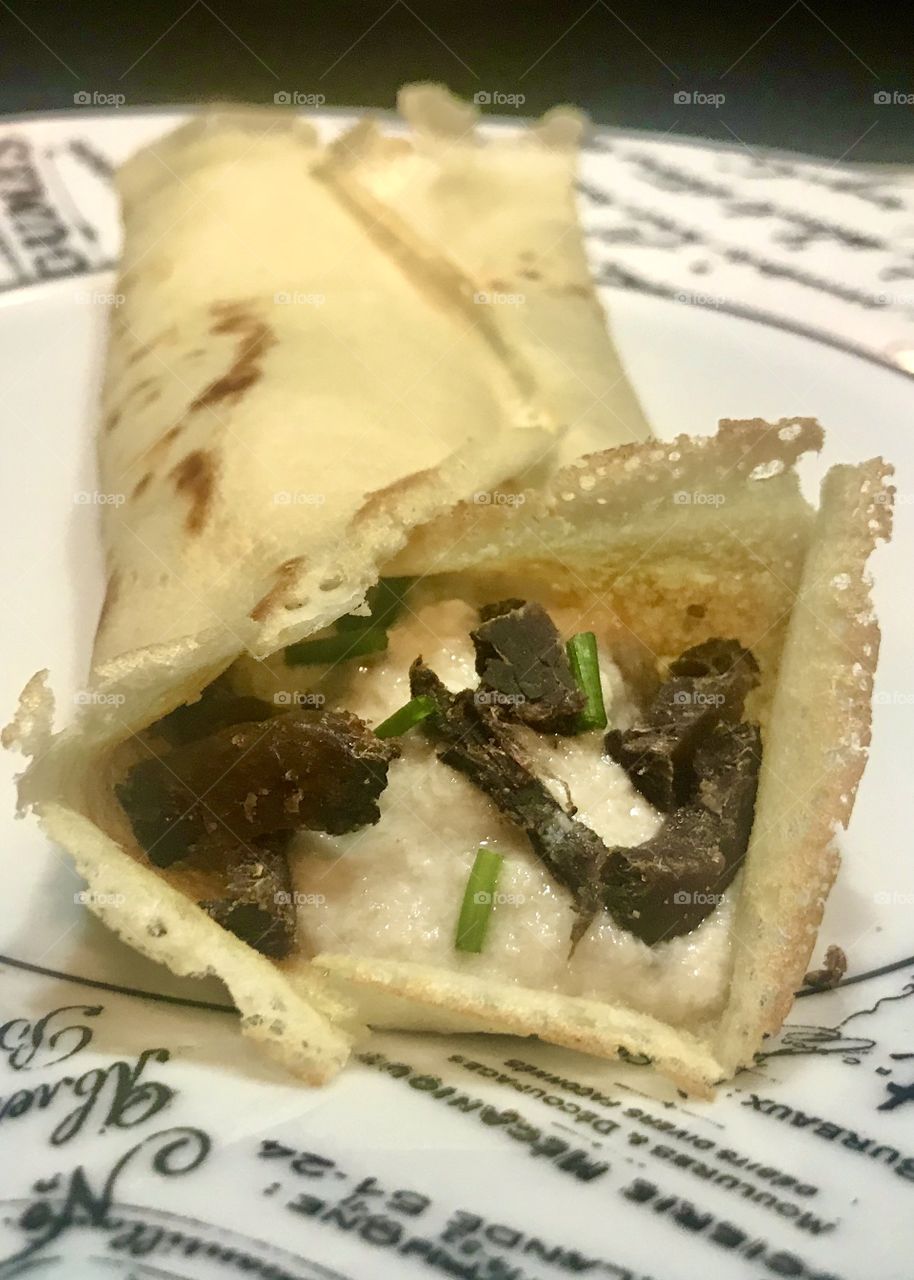 Filled crepe with biltong(cured meat) mushroom sauce and chives 