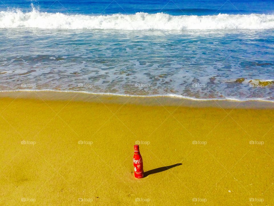 Olympic coke bottle in sand 