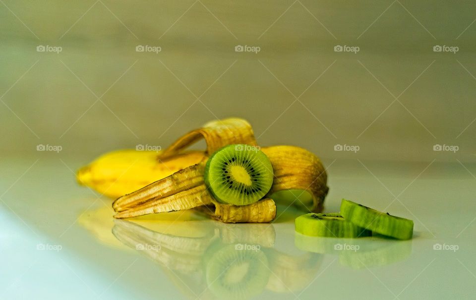 snail on a green leaf ،banana or kiwi?