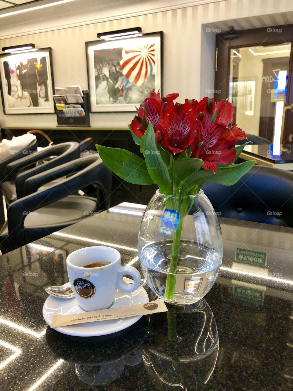 Red flowers bouquet and a cup of coffee on the table 