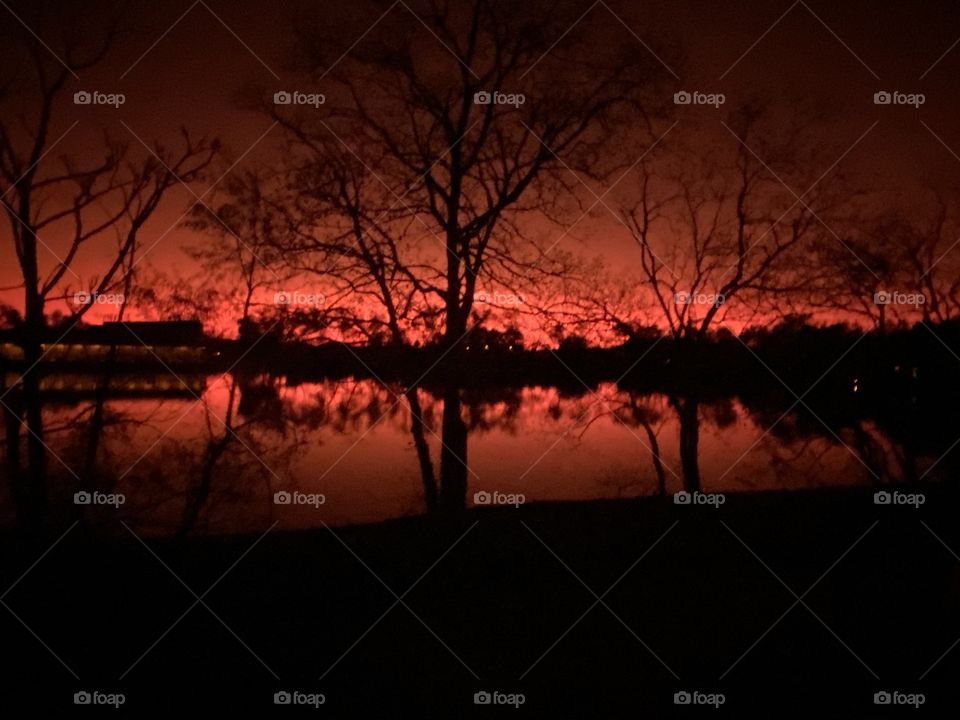 Atmospheric Glow of Beautiful Red Glow. Enchanting Evening to Walk the Lake. Silhouette’s of the Colors towards Reflections from Backlit to Landscapes to the Peaceful Lake Water. WOW to End A Gorgeous Day. 